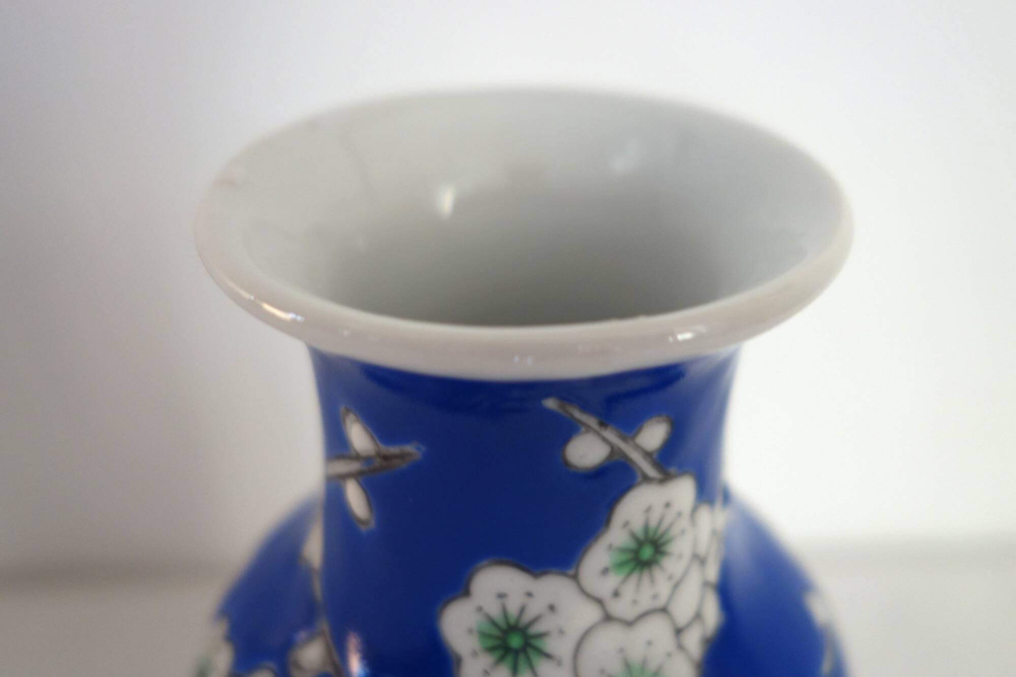 Old blue vase with vintage porcelain cherry blossoms