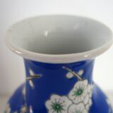 Old blue vase with vintage porcelain cherry blossoms