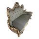 A soft light blue and silver tufted beech wood sofa in Louis style.