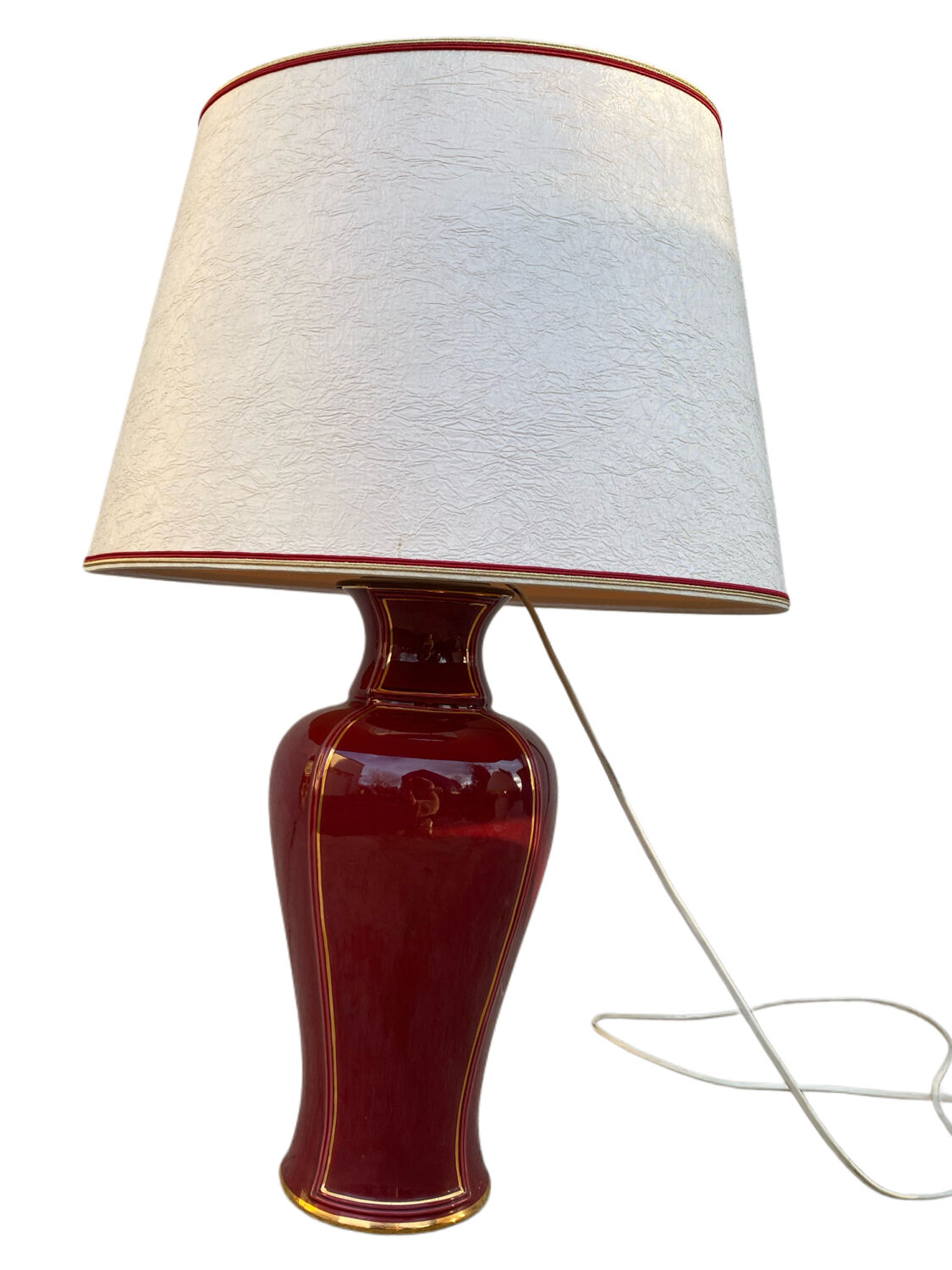 Large burgundy and gold table lamp in vase style.