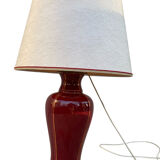 Large burgundy and gold table lamp in vase style.