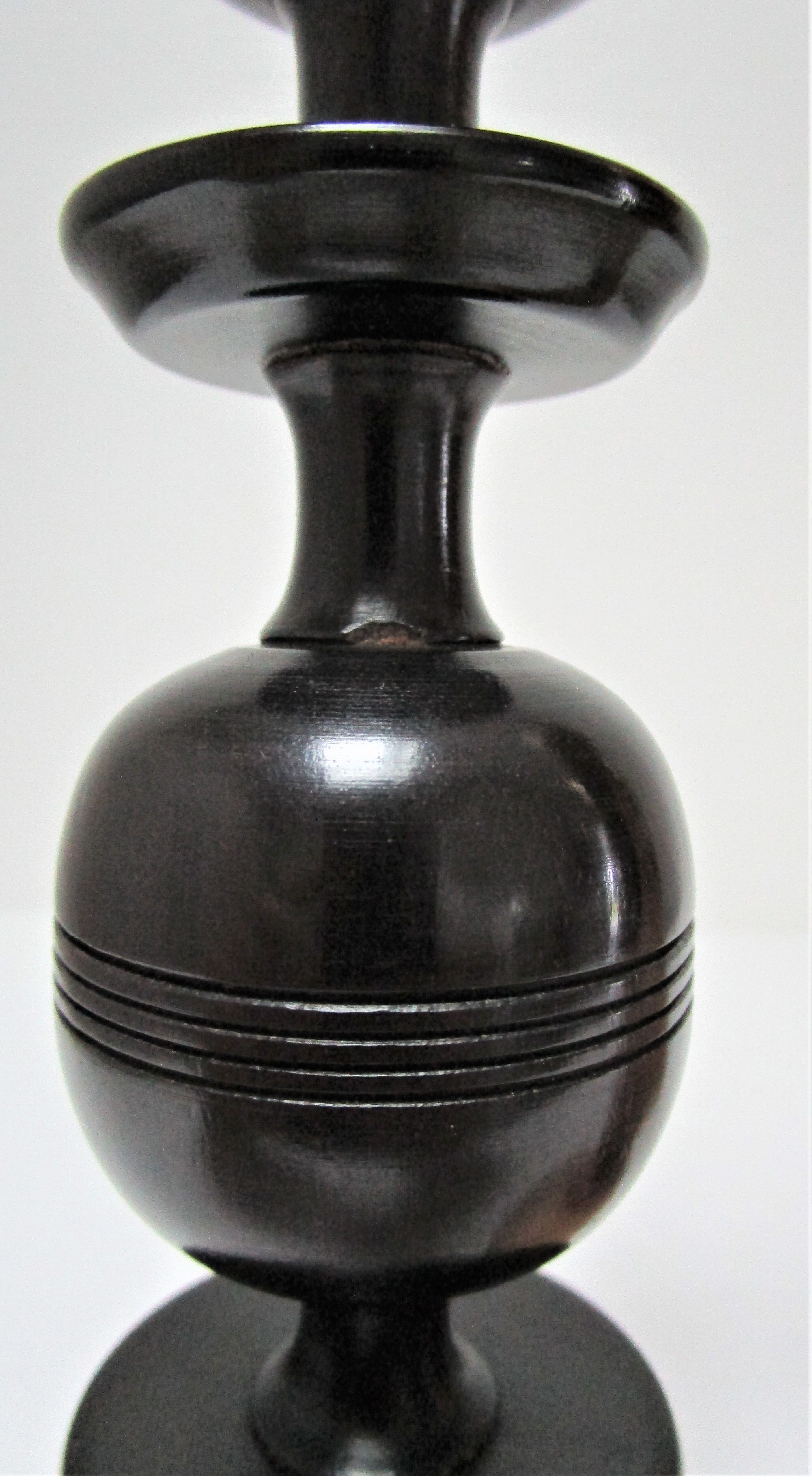 Three vintage light and dark wood candlesticks