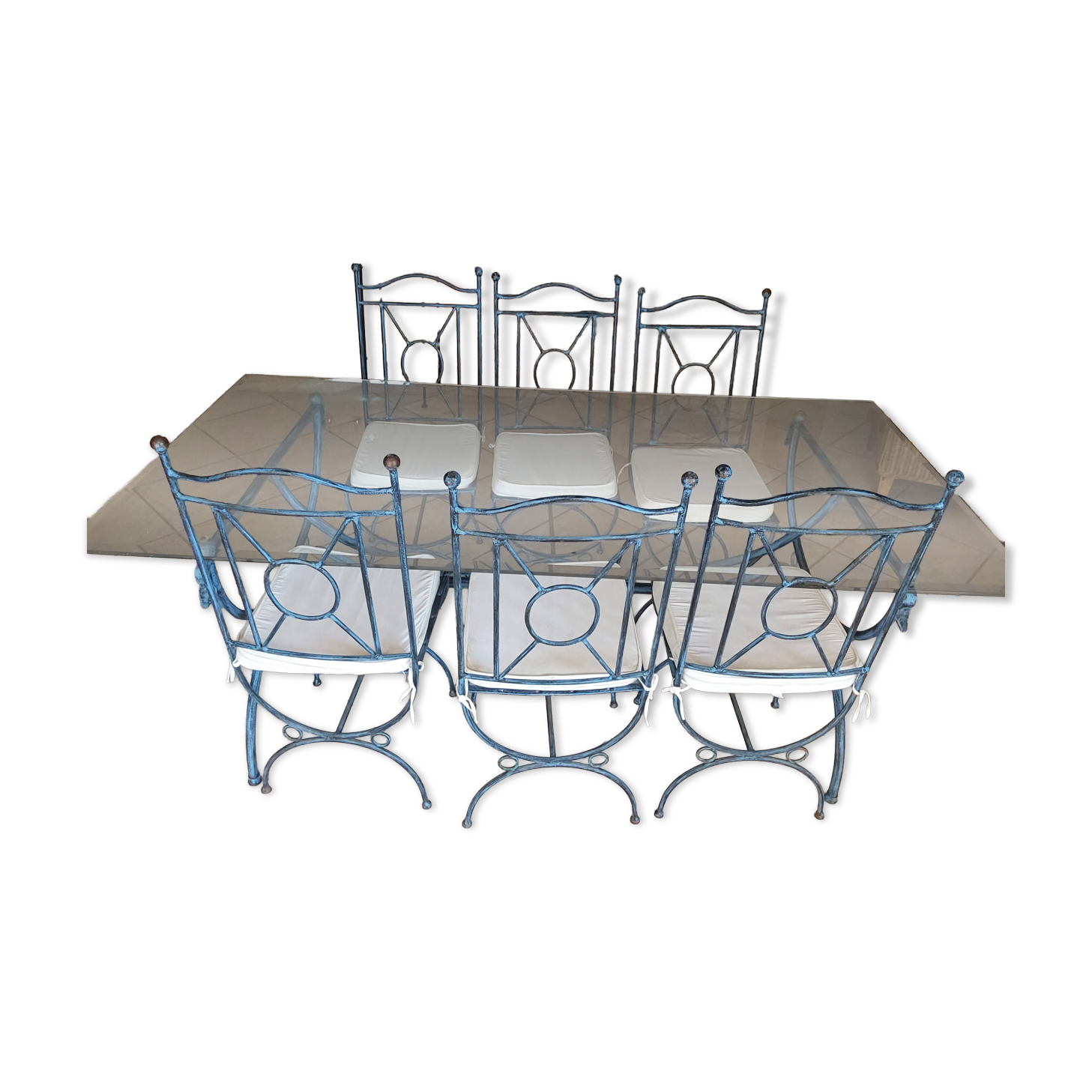 Wrought iron and bevelled glass table with 6 matching chairs.