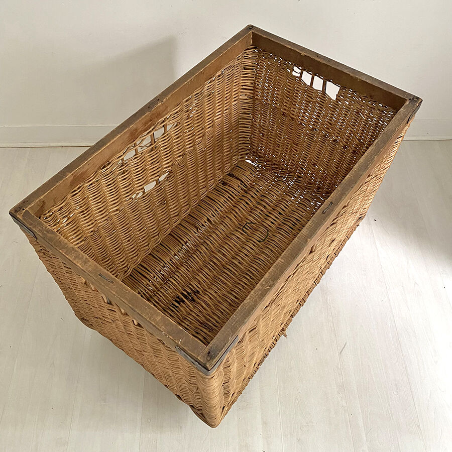 Old large wicker laundry basket on wheels