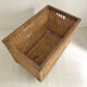 Old large wicker laundry basket on wheels