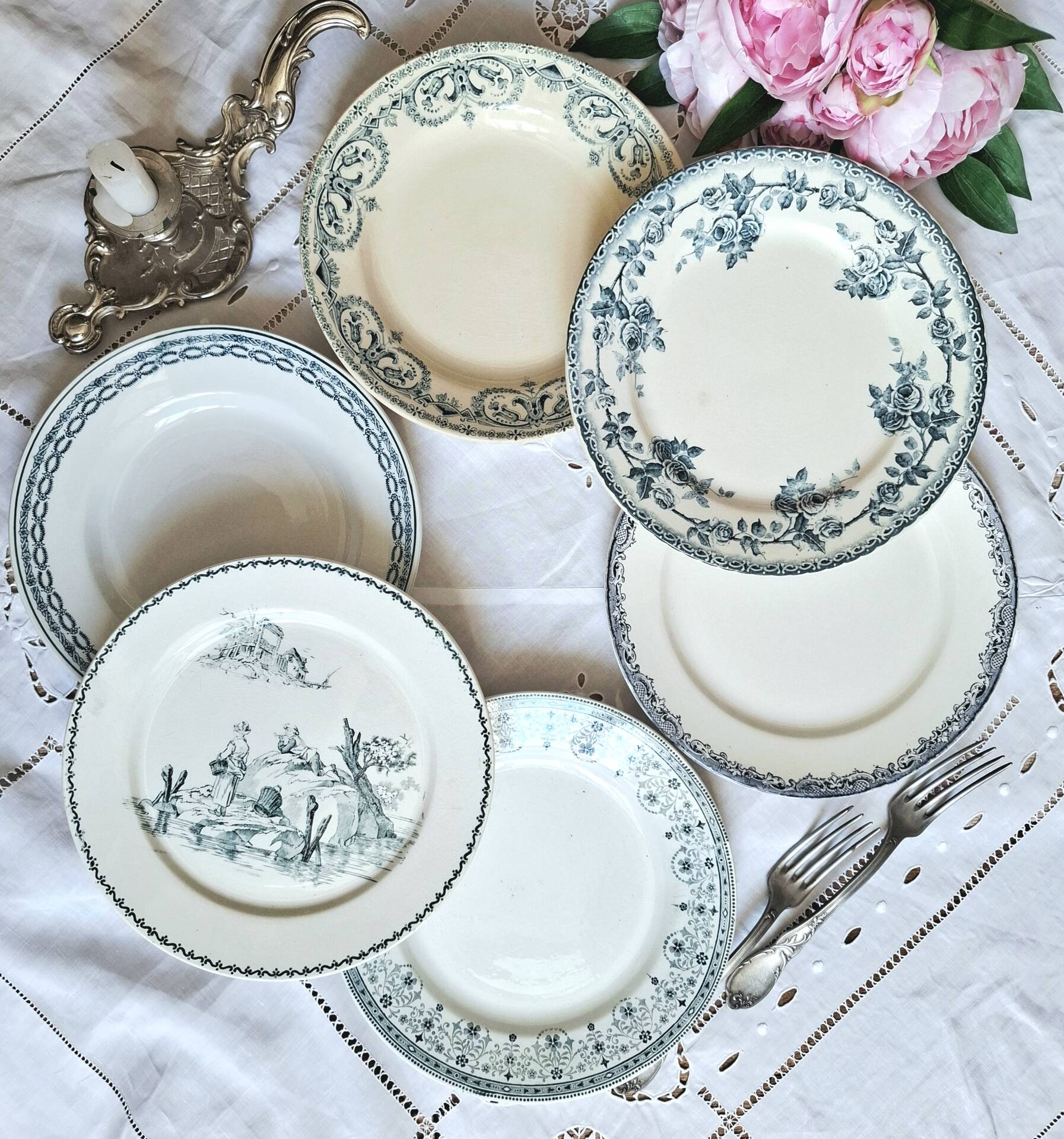 Old mismatched flat plates made of ironstone earthenware.