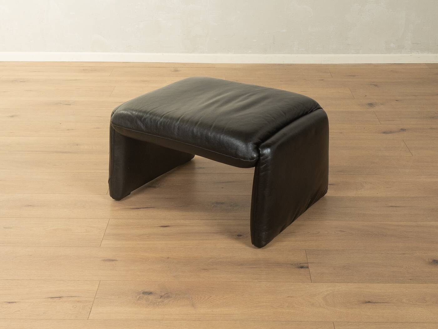 1980s cor armchair and ottoman in black leather