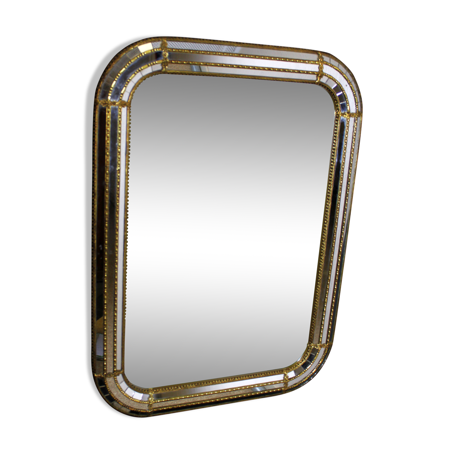 Faceted mirror and gold brass pare closes