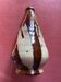 Large antique pottery bottle in glazed terracotta with drips.
