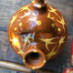 Orange glazed terracotta gargoulette