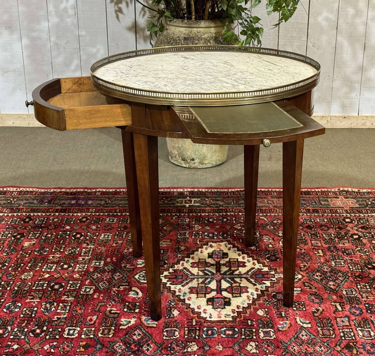 Louis XVI style bouillotte table in mahogany with a white marble top.