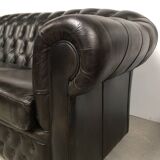 Three-seater black leather chesterfield sofa