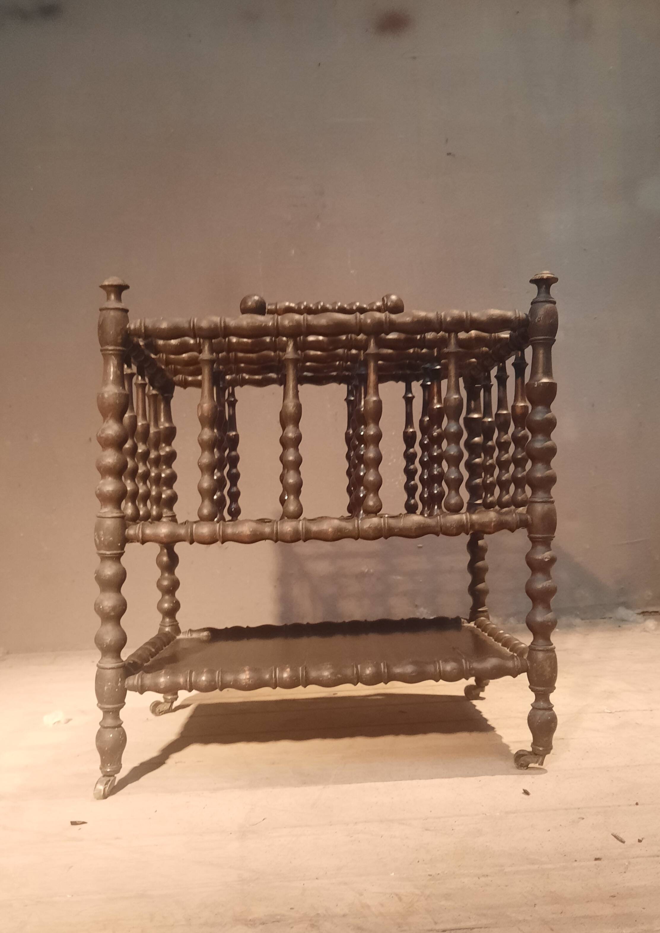 Rosewood magazine rack on casters