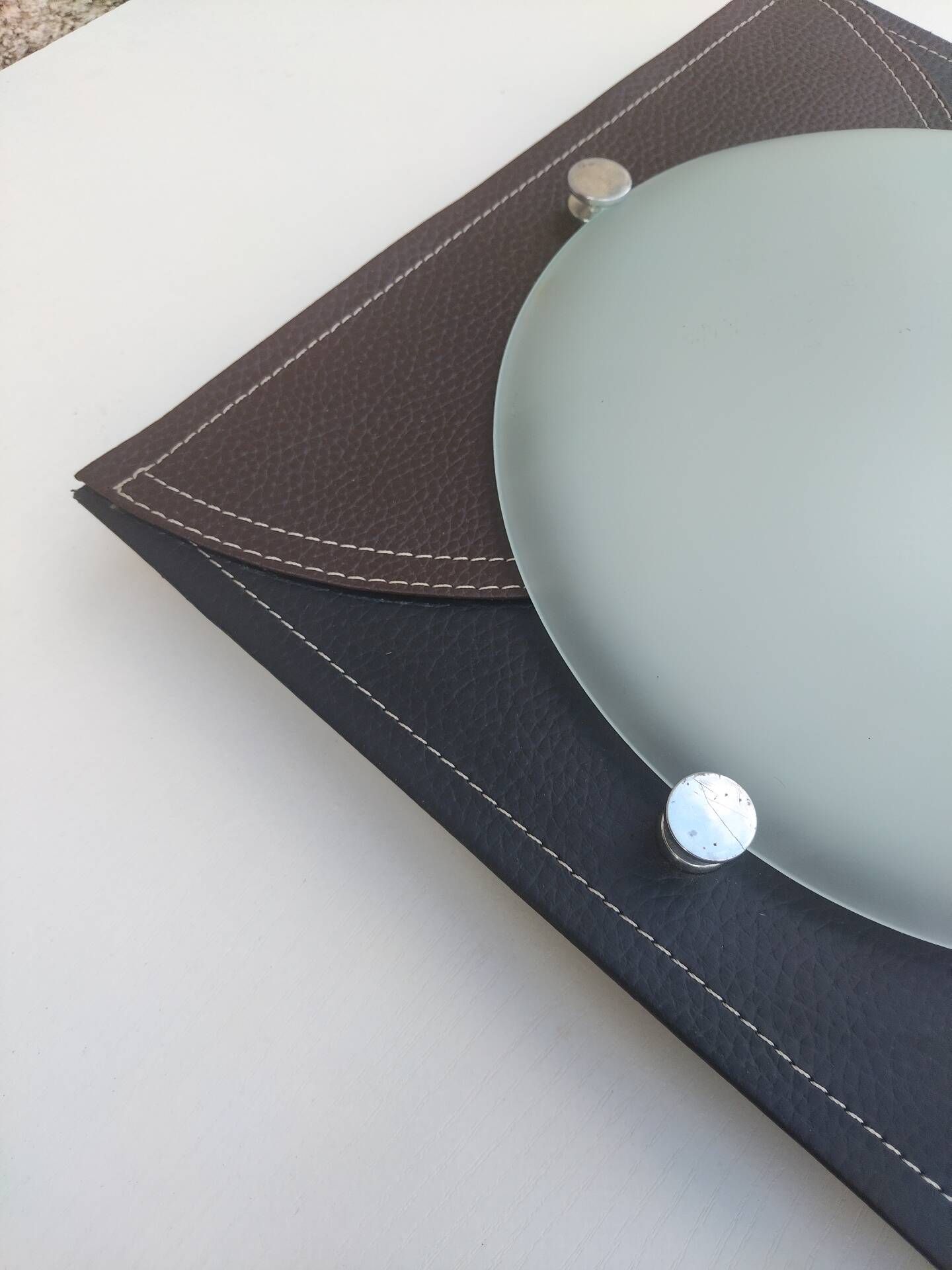 Wall light or ceiling light in frosted glass and leather-like material.