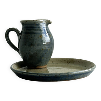 Pitcher and plate in speckled beige and blue enameled ceramic.