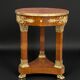 Circular gueridon empire of the 19th century in marquetry ornamented with gilt bronze