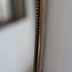 Brass mirror with crest, bead frieze, Italian design style.