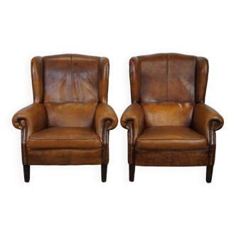 Set of 2 beautiful and correct sheep leather wingback armchairs with fixed seat cushions