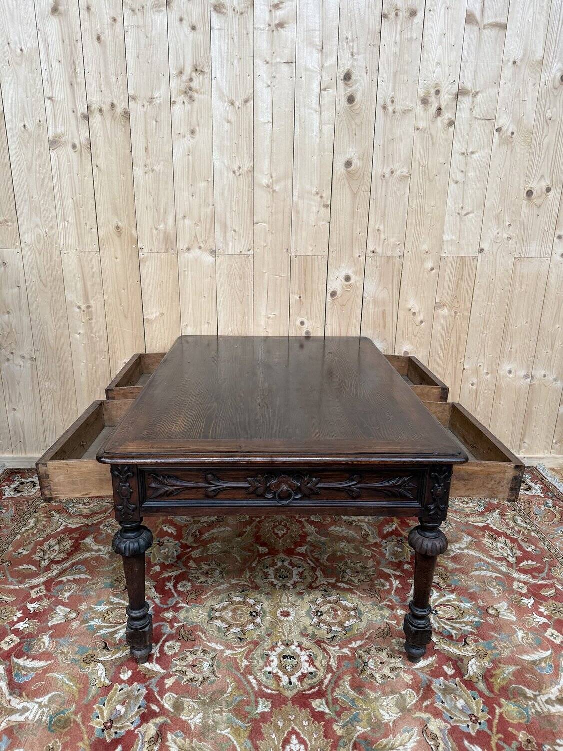 Middle table in a sculpted Louis XIII style living room.
