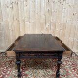 Middle table in a sculpted Louis XIII style living room.