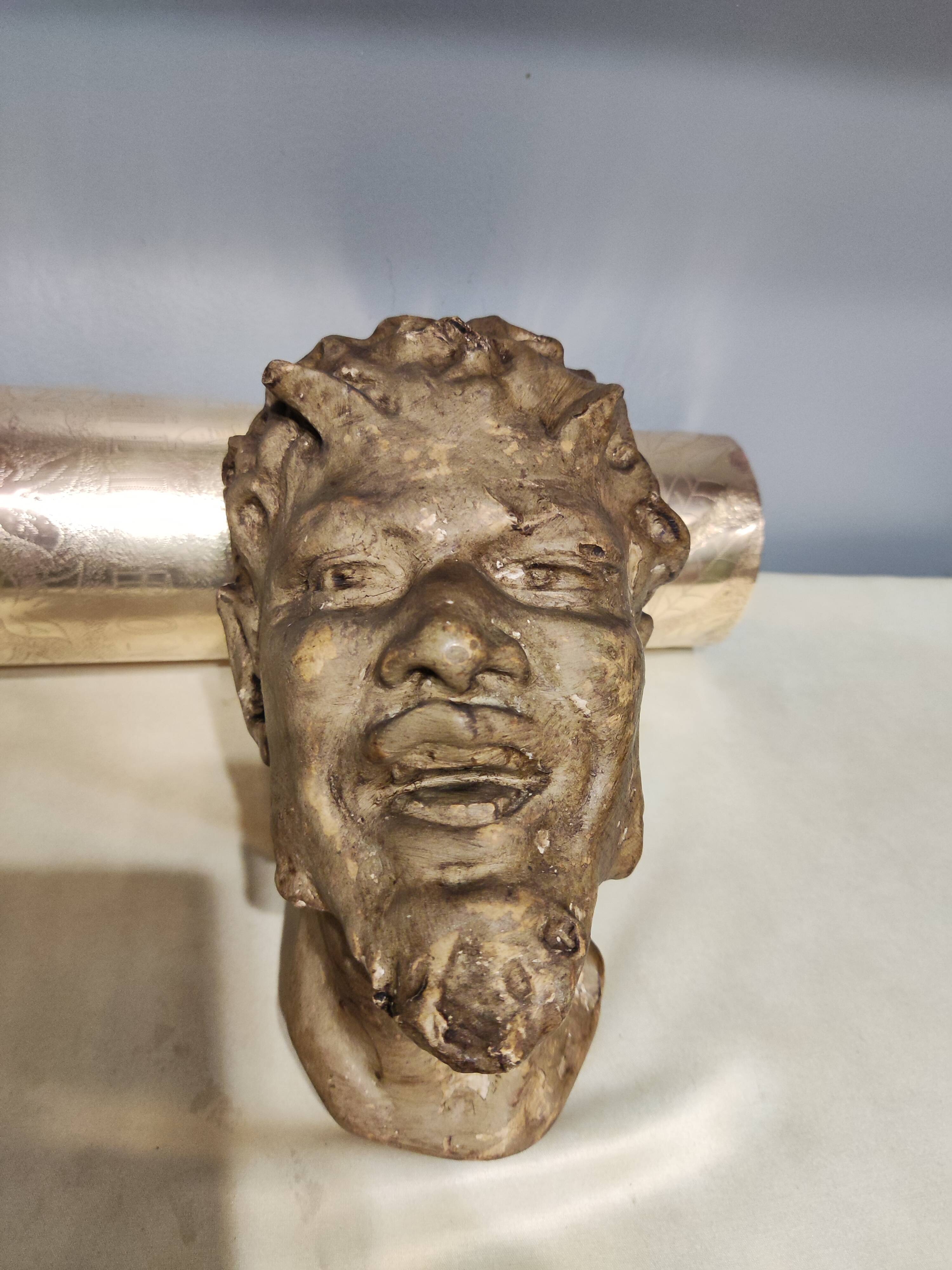 Head of satire in plaster