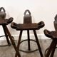 Set of 3 rustic carved oak bar stools with iron footrests, 1970s