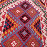 Red carpet with multicolored Berber patterns woven with hands