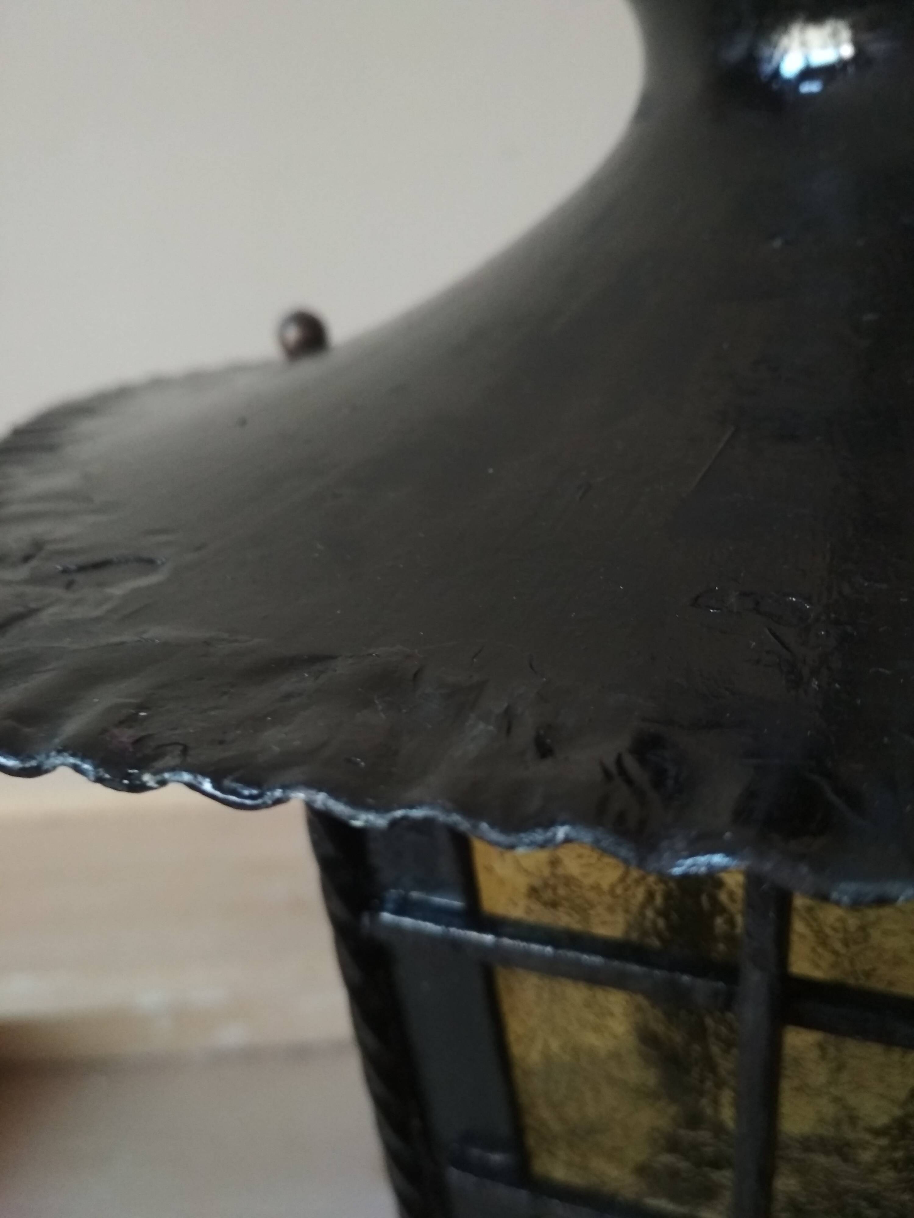 Large hanging lantern in wrought iron and opaque yellow-orange windows