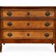 Light walnut commode in Louis XVI style with fluted motifs and three drawers.