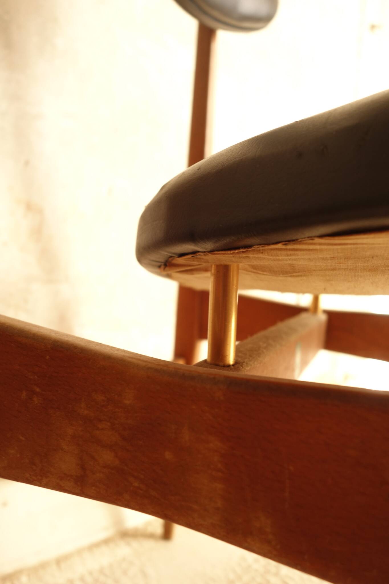 Pair of modernist Scandinavian chairs in teak and black faux leather.
