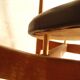 Pair of modernist Scandinavian chairs in teak and black faux leather.