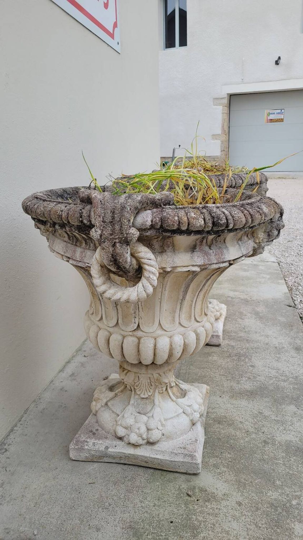 Pair of planter vases decorated with faces in reconstituted stone 1950s