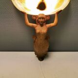 Wall lamp, where the base is a carved wooden lady holding the shade which is made of alabaster 1920s