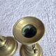 Pair of antique brass candlesticks with adjustable push mechanism from the 19th century.