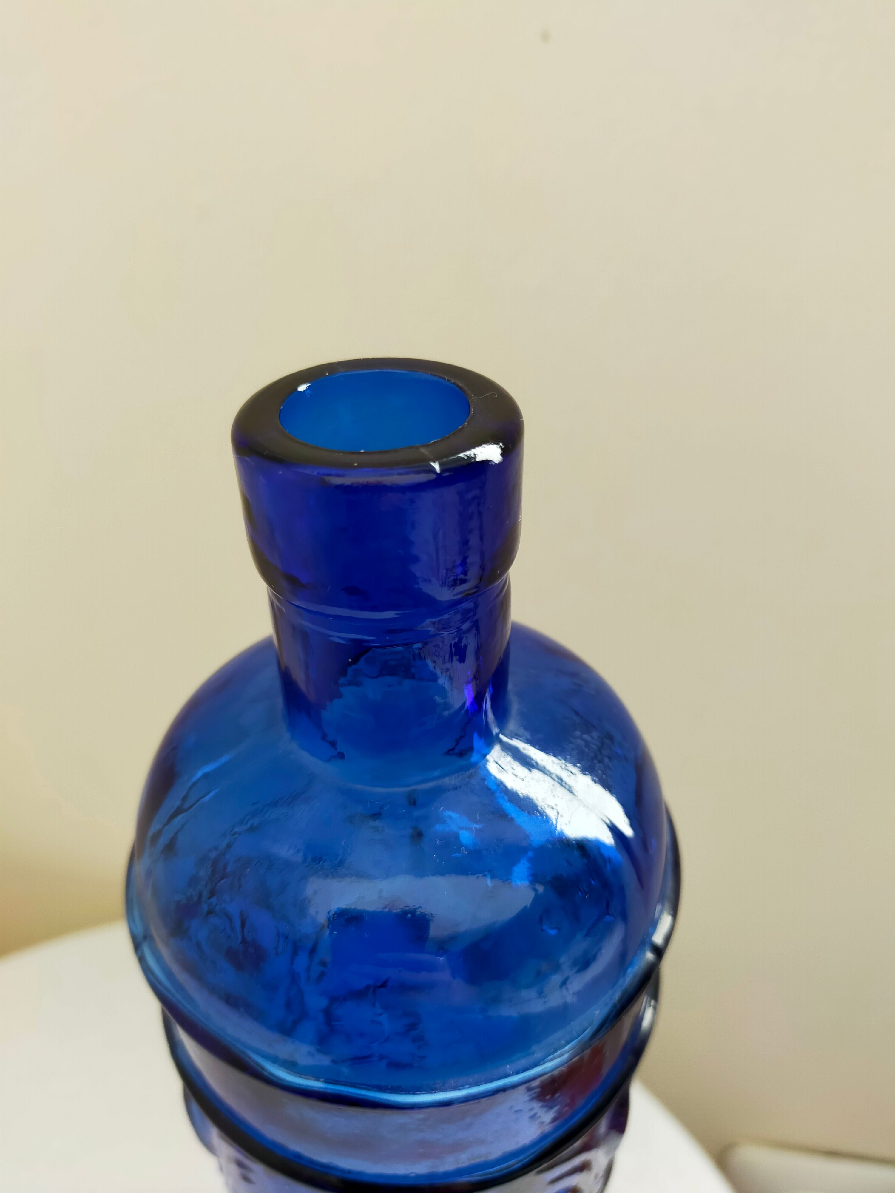 cobalt blue molded glass bottle in relief decoration bunches of grapes