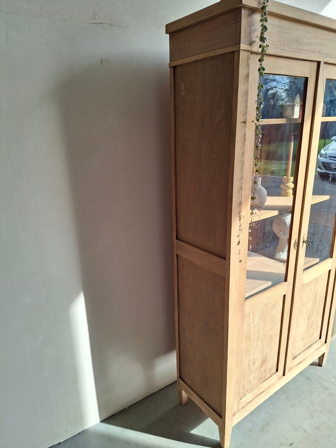 Large antique display cabinet in patinated solid oak.