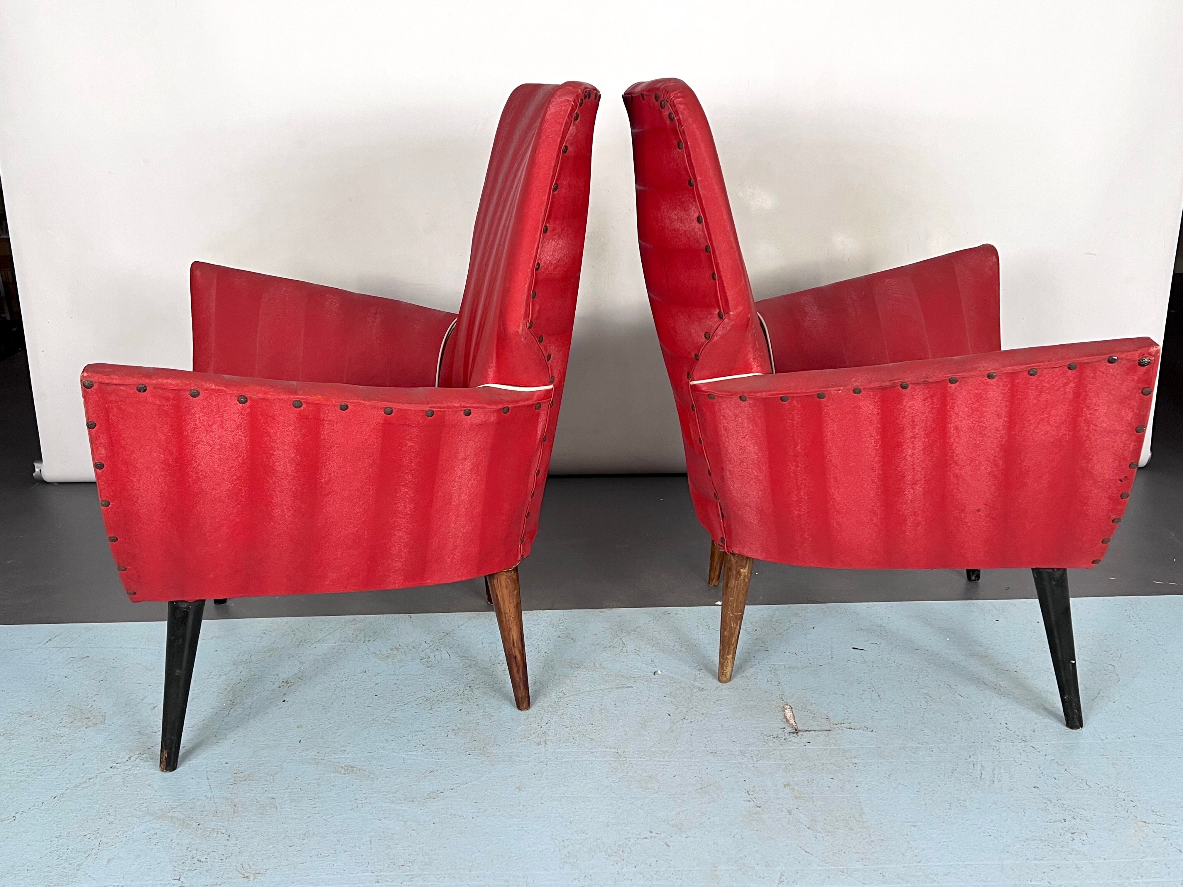 Mid-century modern pair of red armchairs. italy 1950s