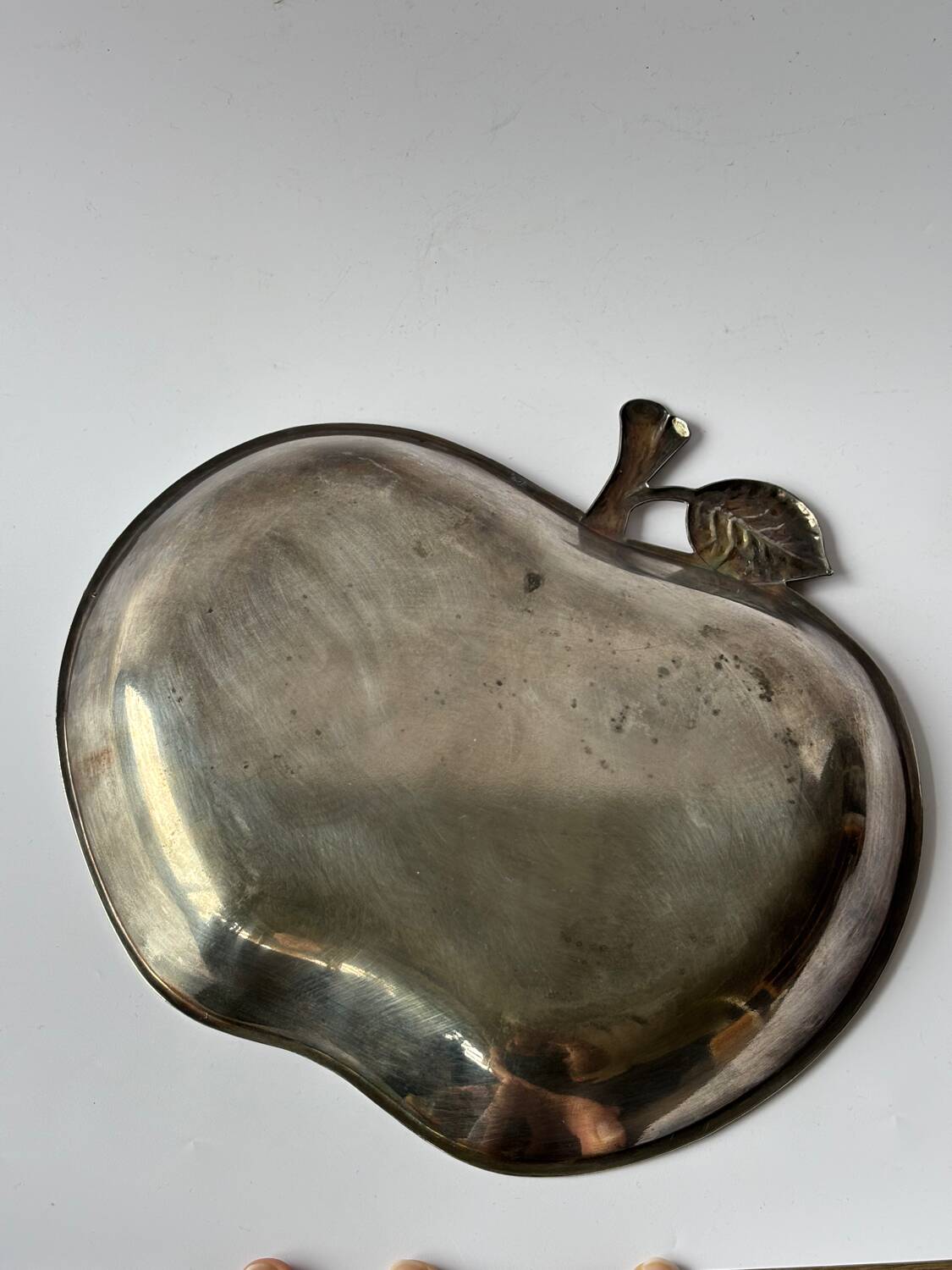 Silver metal apple pocket emptier