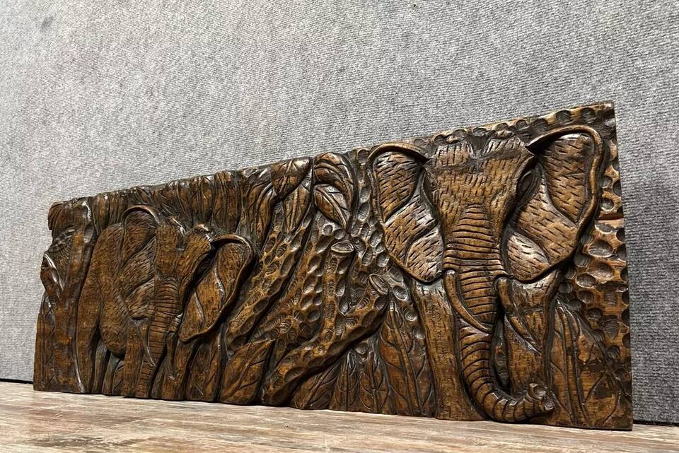 Central Africa 20th century: carved wooden panel in bas-relief of elephants