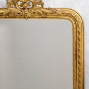 Louis-Philippe mirror from the 19th century with a ribbon trompe-l'œil frame.