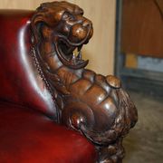 Victorian Chesterfield leather sofa with carved lion heads.