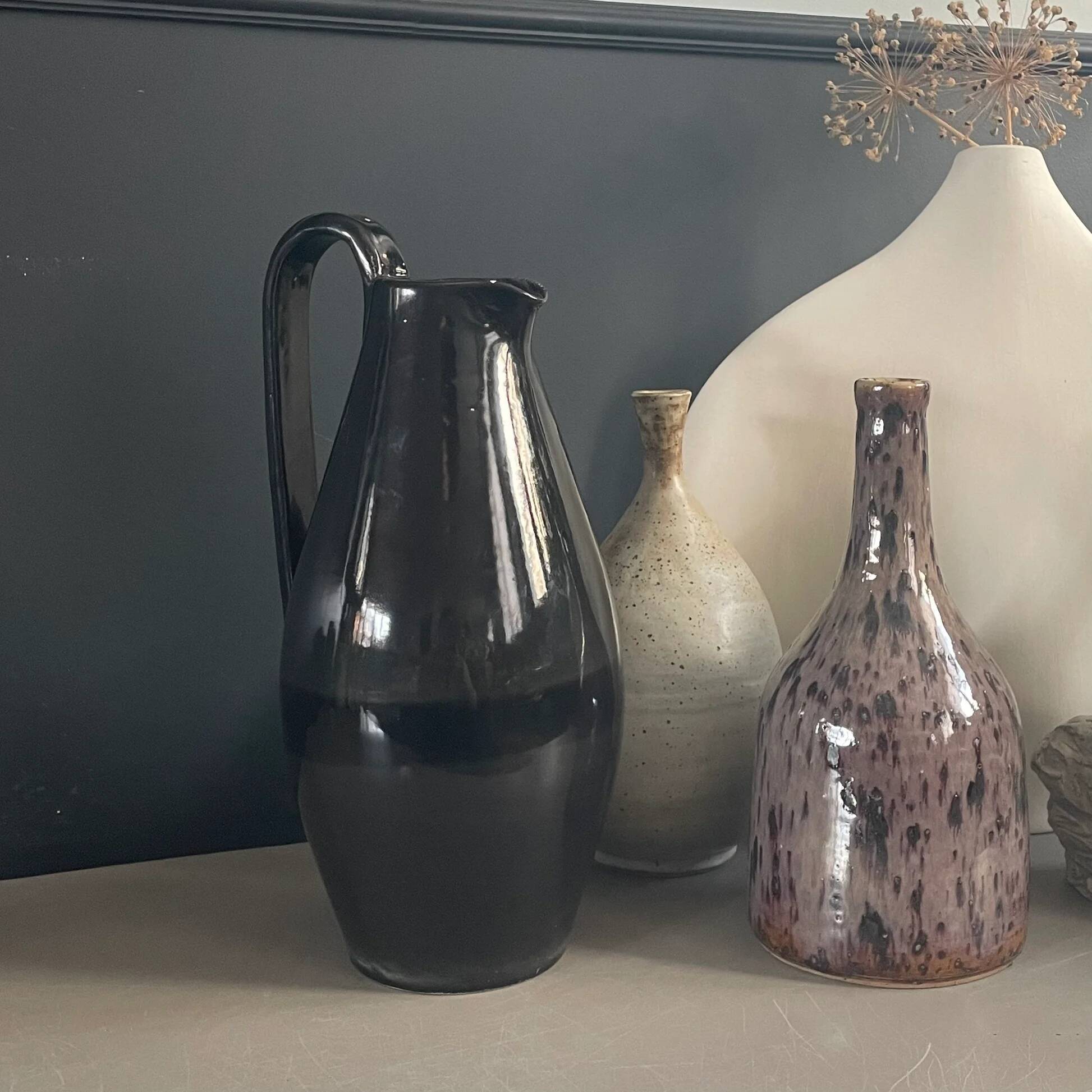 Black glazed ceramic pitcher signed M Azouit