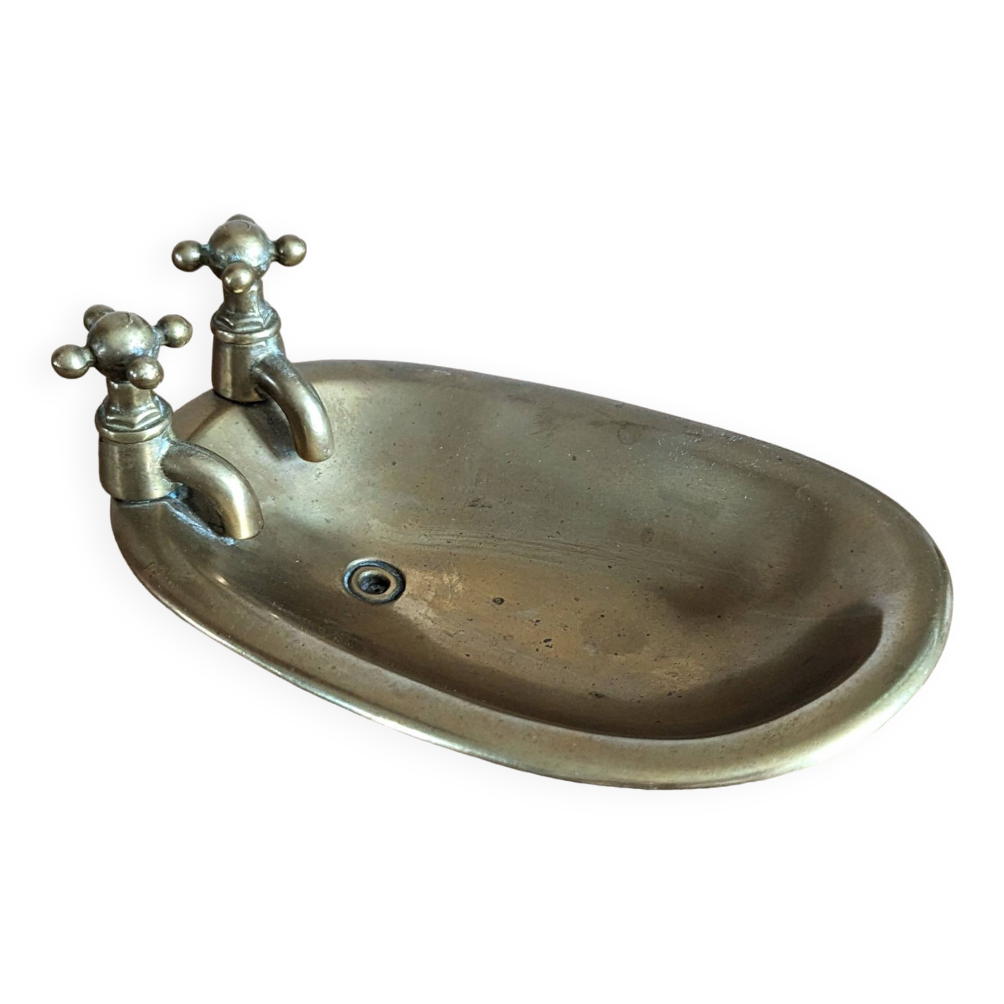 Old soap dish in the shape of a brass bathtub