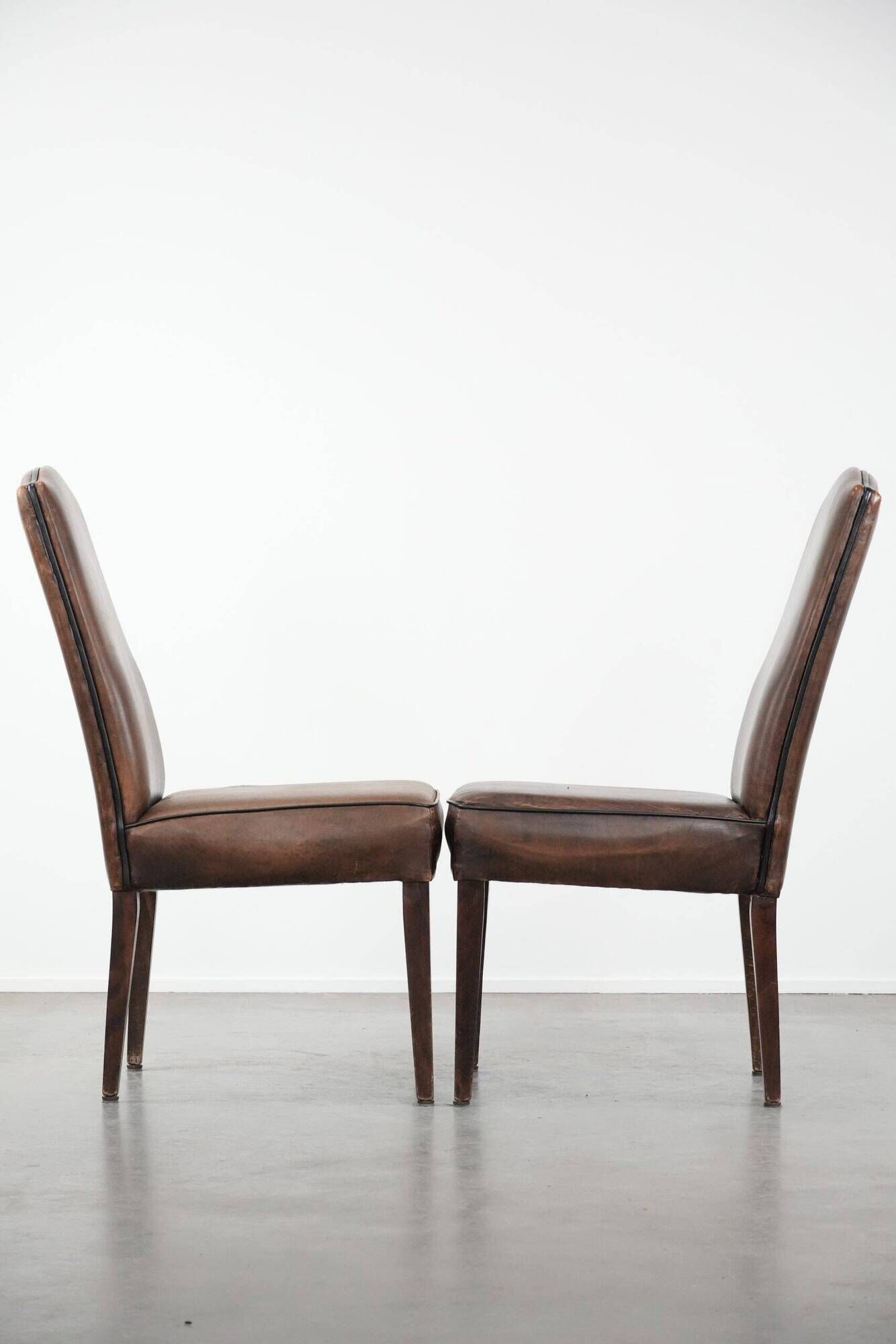 Set of 6 vintage sheepskin dining chairs finished with black piping