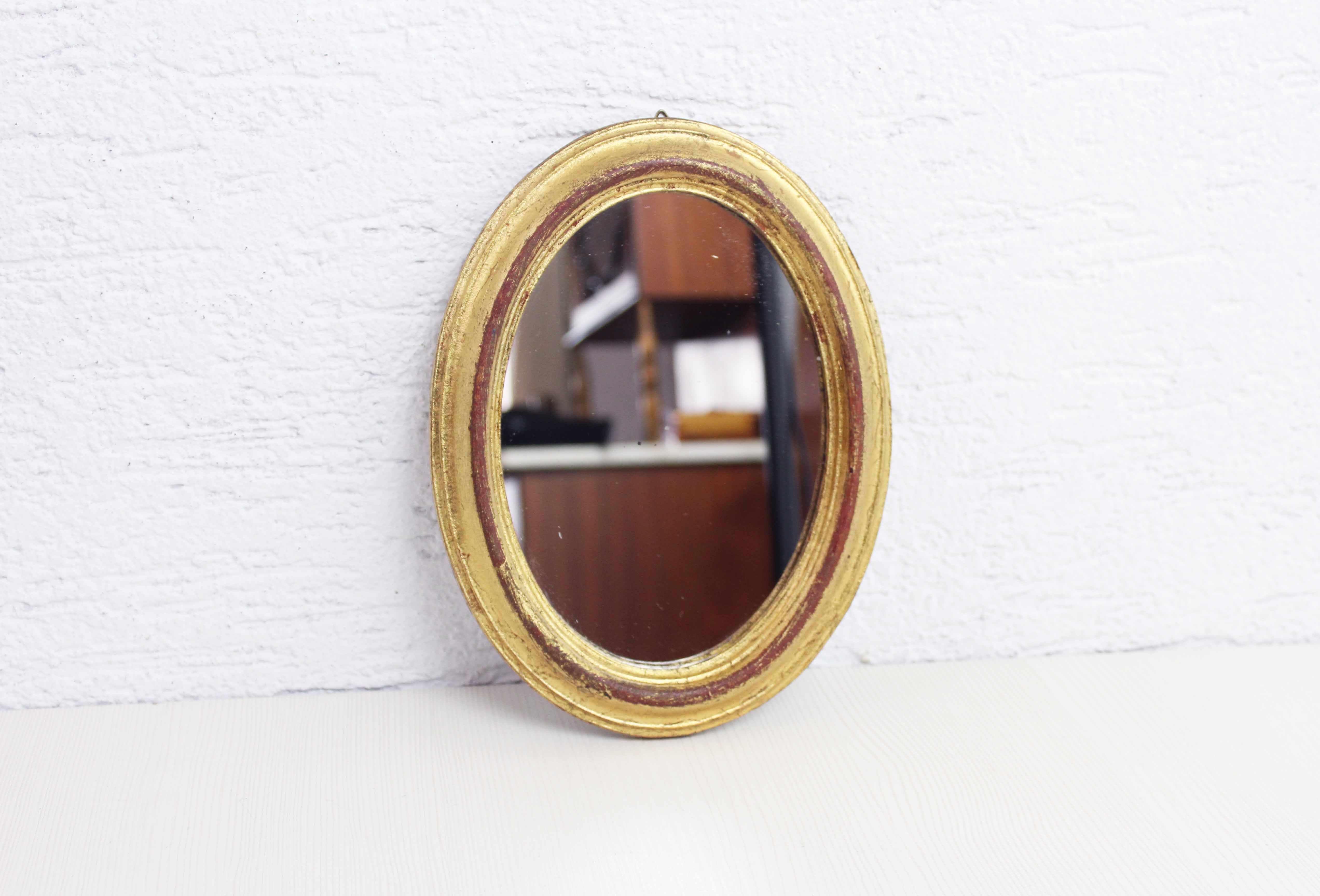 Golden oval mirror