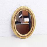 Golden oval mirror