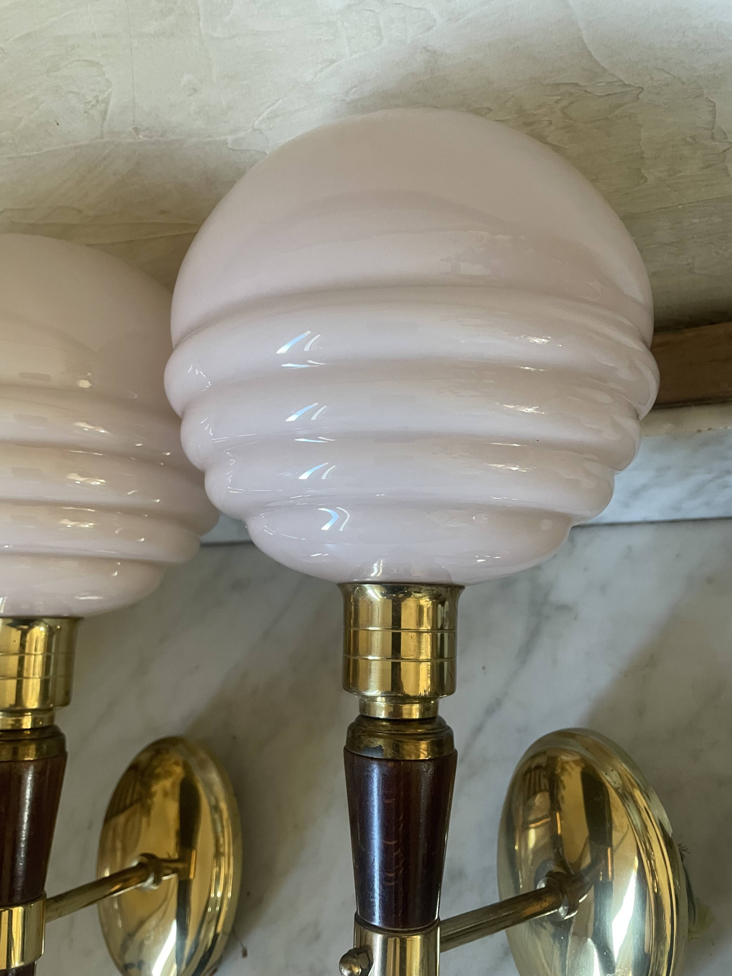 Pair of wall lights in wood, brass, and pink opaline.