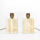 Pair of solid travertine table lamps with incised decoration, French production.