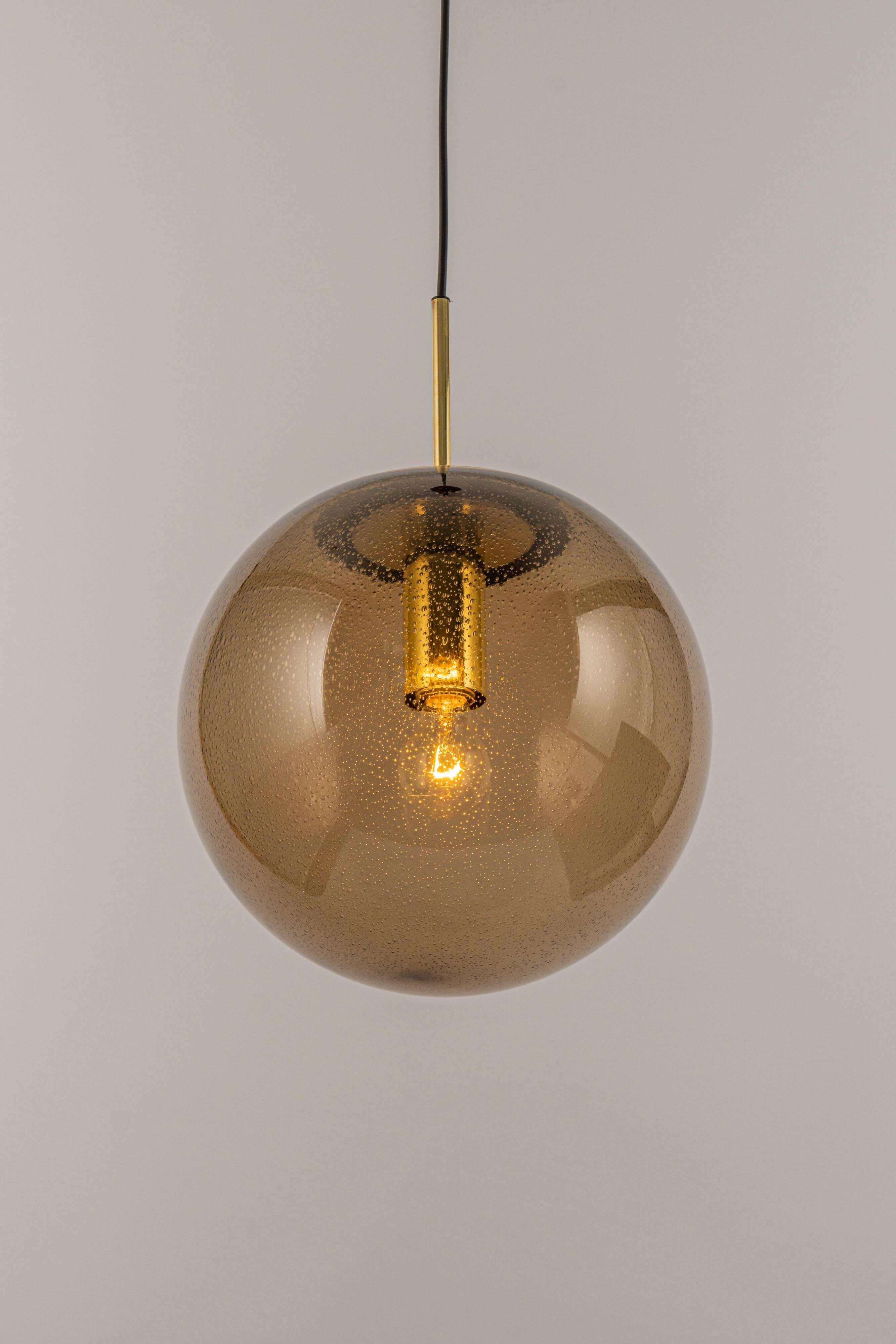 Large smoked glass ball pendant by Limburg with brass, Germany, 1970s.