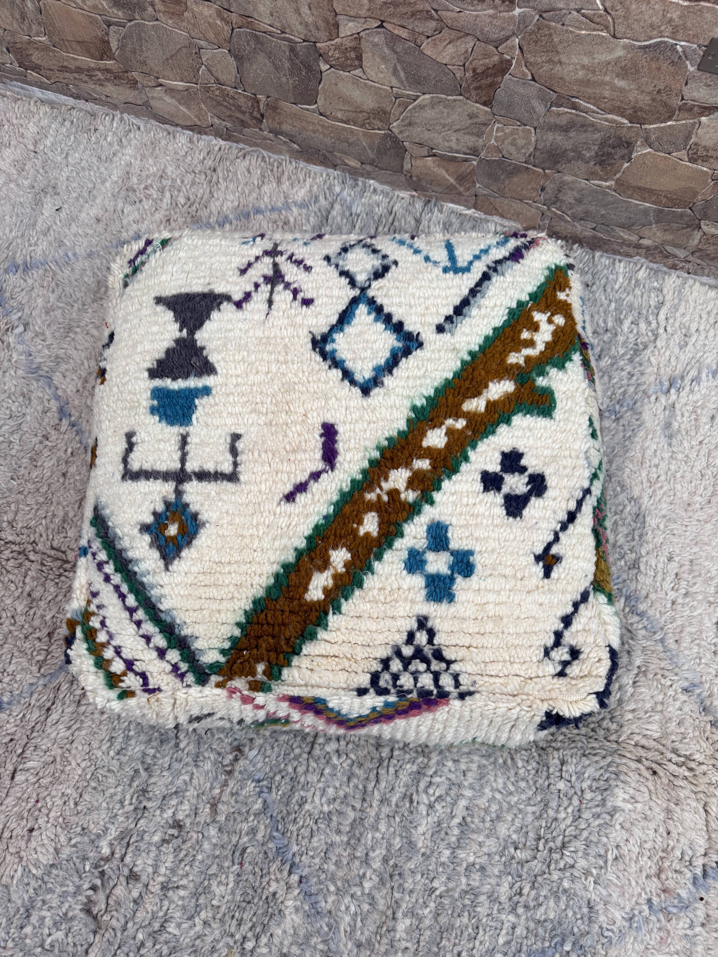 Berber floor pouf: Handwoven Moroccan wool cushion.